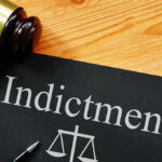 INDICTMENTS Explode: “Feed Kids” Fraud BLOWS OPEN Gavel next to indictment document on wooden table.