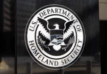 FBI Manhunt FINALLY Nabs Suspect in BRAZEN DHS Assault U.S. Department of Homeland Security emblem on wall.