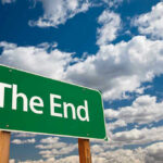 Green sign with white text The End sky background