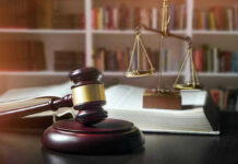 Rapist Brags “It Was Fun” — Judge Caves Gavel, law book, and scales in a library.