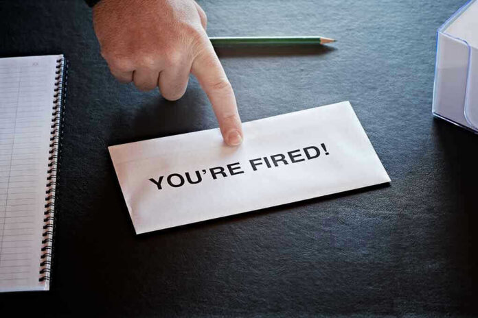 Envelope with YOURE FIRED and pointing finger.