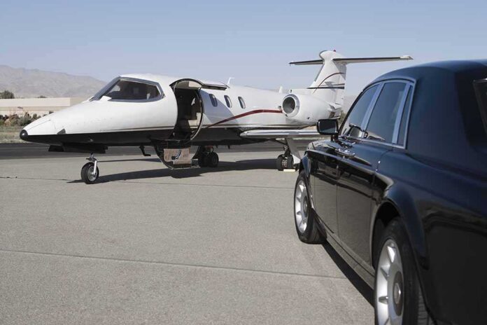 shutterstock_119204140.jpg A private jet parked at an airport with a luxury car in the foreground