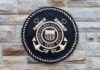 Bronze emblem of the United States Coast Guard mounted on a stone wall