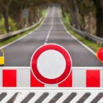 Border UNSEALED After 20 Months—But There’s a Catch Traffic barrier with a red and white sign blocking a road