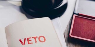 A close-up of a page with the word 'VETO' stamped in red ink