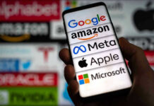 Hand holding phone displaying tech company logos