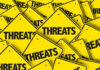 Yellow warning signs with the word THREATS.