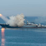 Warship firing missile in the sea.