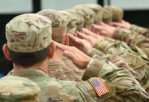 NEW TARGET–New Partnership–Troops On The GROUND Soldiers in uniform saluting, American flag patch visible.