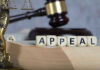 Blocks spelling appeal with gavel and balance scales.