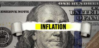 A hundred dollar bill with the word 'INFLATION' prominently displayed across it