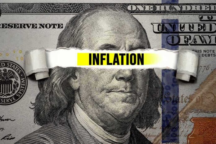 A hundred dollar bill with the word 'INFLATION' prominently displayed across it