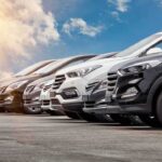 A lineup of modern cars in various colors parked outdoors