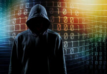 Hooded figure with binary code background.