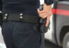 Person holding a gun in a holster.