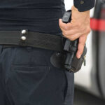 Dozen GUNS Drawn On Teen Playing Water Game Person holding a gun in a holster.