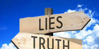 Signs pointing to Lies and Truth against sky.