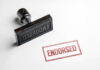 Rubber stamp with ENDORSED text on paper.