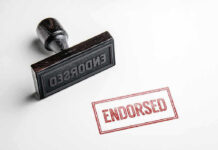 Rubber stamp with ENDORSED text on paper.