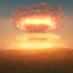 A nuclear explosion creating a large mushroom cloud against a sunset sky