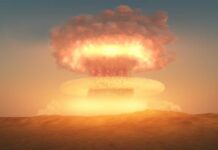 A nuclear explosion creating a large mushroom cloud against a sunset sky