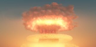 A nuclear explosion creating a large mushroom cloud against a sunset sky