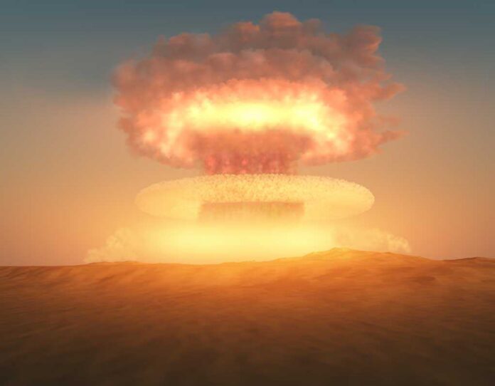 A nuclear explosion creating a large mushroom cloud against a sunset sky