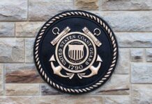Bronze emblem of the United States Coast Guard mounted on a stone wall