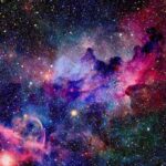 A vibrant cosmic nebula filled with stars and colorful gases
