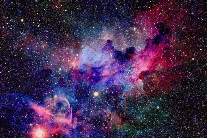 A vibrant cosmic nebula filled with stars and colorful gases