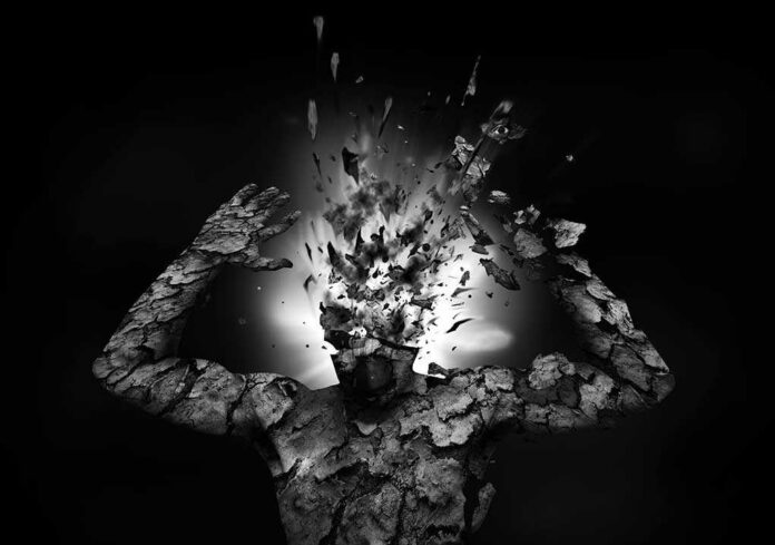 A fragmented human figure with an exploding head in a black and white setting