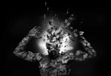 A fragmented human figure with an exploding head in a black and white setting