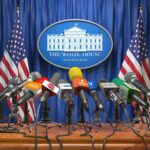 Trump Brokers Three-Day CEASEFIRE Multiple microphones at White House press briefing podium.