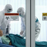 Outrage in Congo: Grieving Families Destroy Health Tents Healthcare workers in protective gear in quarantine room.