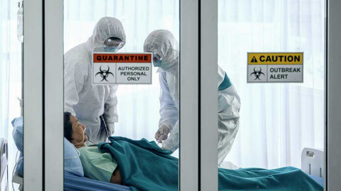 1647350797 Healthcare workers in protective gear in quarantine room.