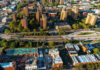 Aerial view of urban area with tall buildings and freeway.