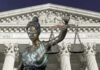 Lawyer Withdraws from High-Stakes Trump Case—Why? Lady Justice statue in front of courthouse.