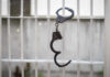 Former PM’S Release Sparks OUTRAGE — ELITES Above Law? Handcuffs hanging on a barred window.