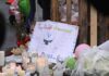 Tragedy In Shreveport: Eight Child Coffins A memorial site with candles, flowers, and a hand-drawn poster