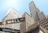 Deforestation Cover-Up: Wall Street’s Secret Votes Street signs for Wall Street and Broad Street with skyscrapers in the background