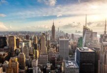 Bezos UNLEASHES Truth Bomb on NYC Aerial view of New York City skyline featuring the Empire State Building at sunset