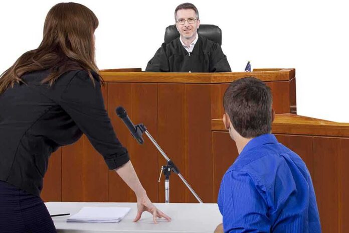 shutterstock_210545800 A judge presiding over a courtroom with a lawyer speaking to the court