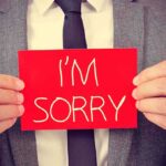 Judge Blasts Jail — APOLOGIZES to Trumps’s Would-be Assassin! A man in a suit holding a red sign that says IM SORRY