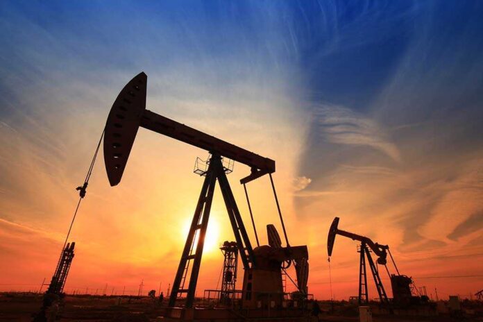 shutterstock_525767236-1 Silhouetted oil pumps against a colorful sunset sky