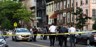 Police gathered at an urban crime scene.