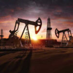 Russia Admits Fuel Crisis—Lines Explode Oil rigs operating at sunset in a desert landscape.