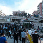 Dozens Dead After 7.8 Quake People at a collapsed building after an earthquake.