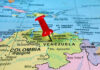 US Strike Claim on Tren de Aragua Leader Red pin on Venezuela, South America map.