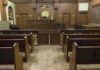 Self-Defense Rejected, Sentence Handed Down Interior view of an empty courtroom with wooden benches and a judges bench