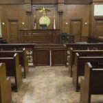 Self-Defense Rejected, Sentence Handed Down Interior view of an empty courtroom with wooden benches and a judges bench